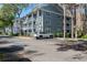 Two-story condo building with parking and tree-lined street at 2511 Dolly Bay Dr # 303, Palm Harbor, FL 34684