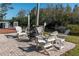 Relaxing fire pit area with white Adirondack chairs at 2511 Dolly Bay Dr # 303, Palm Harbor, FL 34684