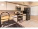 Modern kitchen with stainless steel appliances and granite countertops at 2511 Dolly Bay Dr # 303, Palm Harbor, FL 34684