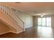 Spacious living room with wood-look floors and access to balcony at 2511 Dolly Bay Dr # 303, Palm Harbor, FL 34684