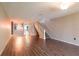 Bright living room features wood-look floors and staircase at 2511 Dolly Bay Dr # 303, Palm Harbor, FL 34684