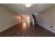 Spacious living room with wood-look floors and staircase at 2511 Dolly Bay Dr # 303, Palm Harbor, FL 34684
