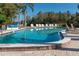 Community pool with lounge chairs and surrounding patio at 2511 Dolly Bay Dr # 303, Palm Harbor, FL 34684