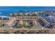 Aerial view showcasing townhome community near waterfront with tennis courts at 262 Madeira Cir, Tierra Verde, FL 33715