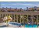 Balcony with glass-top table and flowers overlooking the pool at 262 Madeira Cir, Tierra Verde, FL 33715