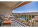 Private balcony with wicker furniture and partial pool view at 262 Madeira Cir, Tierra Verde, FL 33715