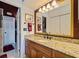 Bathroom with granite countertop and large mirror at 262 Madeira Cir, Tierra Verde, FL 33715