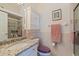 Small bathroom with granite countertop and shower at 262 Madeira Cir, Tierra Verde, FL 33715