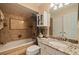 Updated bathroom with granite countertop and tile shower at 262 Madeira Cir, Tierra Verde, FL 33715