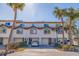 Two story townhome with attached garage and palm trees at 262 Madeira Cir, Tierra Verde, FL 33715