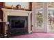 Elegant fireplace with a granite hearth and mirror at 262 Madeira Cir, Tierra Verde, FL 33715