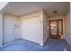 Attached garage with front entrance and access to home at 262 Madeira Cir, Tierra Verde, FL 33715