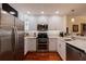 Modern kitchen with stainless steel appliances and granite countertops at 262 Madeira Cir, Tierra Verde, FL 33715