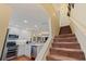 Stairs leading upstairs to bedrooms, with kitchen view at 262 Madeira Cir, Tierra Verde, FL 33715