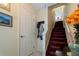 Interior view of carpeted staircase and coat rack at 262 Madeira Cir, Tierra Verde, FL 33715
