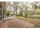 Brick patio with a white picket fence, overlooking a pond at 3143 Brooker Creek Way, Palm Harbor, FL 34685