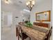 Elegant dining room showcasing a marble-top table and access to the living room and bath at 3143 Brooker Creek Way, Palm Harbor, FL 34685