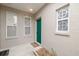 Inviting front entry with teal door and decorative window inserts at 3143 Brooker Creek Way, Palm Harbor, FL 34685