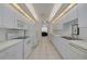 Well-equipped kitchen with white cabinetry, tile floors, and a view to the dining area at 3143 Brooker Creek Way, Palm Harbor, FL 34685