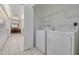Bright laundry room with washer, dryer and shelving at 3143 Brooker Creek Way, Palm Harbor, FL 34685