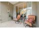 Relaxing patio with two chairs and a small table, overlooking greenery at 3143 Brooker Creek Way, Palm Harbor, FL 34685