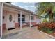 Inviting front porch with a white bench and pink walls at 3530 25Th N Ave, St Petersburg, FL 33713