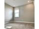 Bright bedroom with carpeted floor and large window at 4861 Tramanto Ln, Wesley Chapel, FL 33543