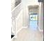 Bright and spacious entryway with tiled floors and staircase at 4861 Tramanto Ln, Wesley Chapel, FL 33543