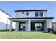 Two-story house with covered patio and backyard at 4861 Tramanto Ln, Wesley Chapel, FL 33543