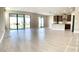Open living room with tile floor and sliding glass doors at 4861 Tramanto Ln, Wesley Chapel, FL 33543