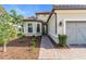 Front entrance with walkway, landscaping, and two-car garage at 5287 Rushmere Ct, Palmetto, FL 34221