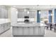 Modern kitchen with large island, gray cabinets, and stainless steel appliances at 5287 Rushmere Ct, Palmetto, FL 34221