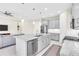 Modern kitchen with gray cabinets, granite island, and stainless steel appliances at 5287 Rushmere Ct, Palmetto, FL 34221