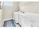 Bright laundry room with white cabinets and shelving at 5287 Rushmere Ct, Palmetto, FL 34221