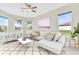Living area with comfortable seating, large windows, and ceiling fan at 5287 Rushmere Ct, Palmetto, FL 34221