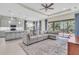 Open concept living room and kitchen with a large sectional sofa and patio access at 5287 Rushmere Ct, Palmetto, FL 34221