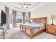 Large main bedroom with wood furniture and bay window at 5287 Rushmere Ct, Palmetto, FL 34221