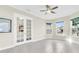 Bright home office with French doors, built-in shelving, and large windows at 5287 Rushmere Ct, Palmetto, FL 34221