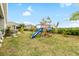 Landscaped backyard with playground and plenty of green space at 6189 Hidden Branch Dr, Apollo Beach, FL 33572