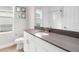 Modern bathroom with gray vanity, white cabinets, and a walk-in shower at 6189 Hidden Branch Dr, Apollo Beach, FL 33572