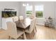 Bright dining room featuring a wooden table and six chairs, with a large aquarium at 6189 Hidden Branch Dr, Apollo Beach, FL 33572