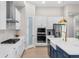 Modern kitchen with white cabinets, stainless steel appliances, and a large island at 6189 Hidden Branch Dr, Apollo Beach, FL 33572