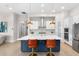 Modern kitchen with white cabinets, large island, and stainless steel appliances at 6189 Hidden Branch Dr, Apollo Beach, FL 33572
