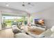Living room with sliding doors to the backyard, light colored sofas and large TV at 6189 Hidden Branch Dr, Apollo Beach, FL 33572
