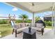 Covered patio with comfortable seating and views of backyard at 6189 Hidden Branch Dr, Apollo Beach, FL 33572