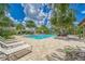 Community pool with lounge chairs and palm trees at 6189 Hidden Branch Dr, Apollo Beach, FL 33572
