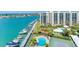 Aerial view of waterfront community with pool and tennis court at 660 Island Way # 1005, Clearwater Beach, FL 33767