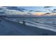 People relaxing on a sandy beach at sunset at 660 Island Way # 1005, Clearwater Beach, FL 33767