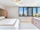 Bright bedroom with water view and king-size bed at 660 Island Way # 1005, Clearwater Beach, FL 33767