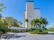 High-rise building with covered parking and landscaping at 660 Island Way # 1005, Clearwater Beach, FL 33767
